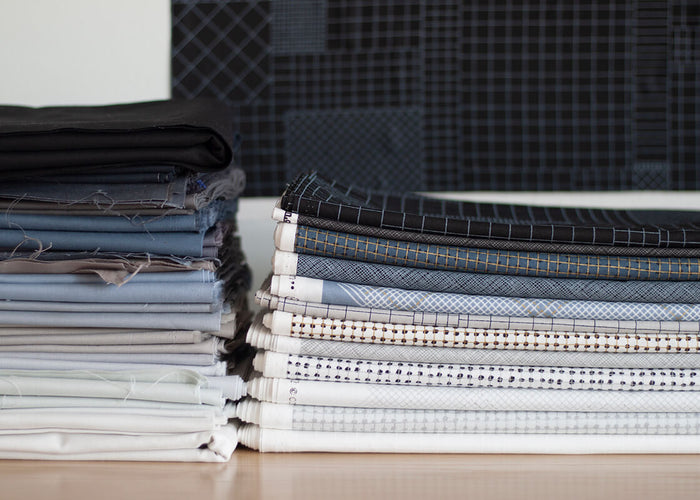 CF grid group fabrics stacked up next to Kona Cotton solids