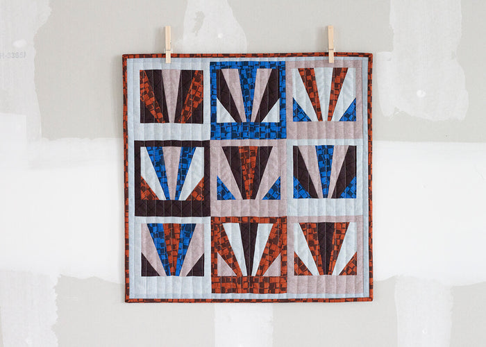 mini quilt with sunrise blocks in light and dark fabrics