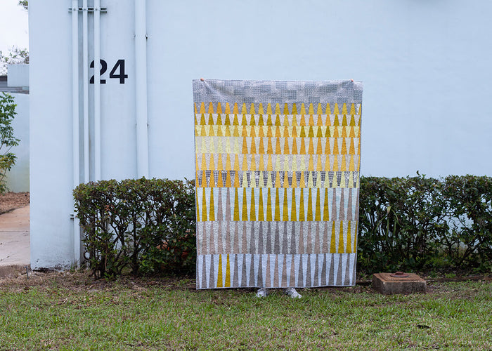 yellow and grey quilt with triangular motif