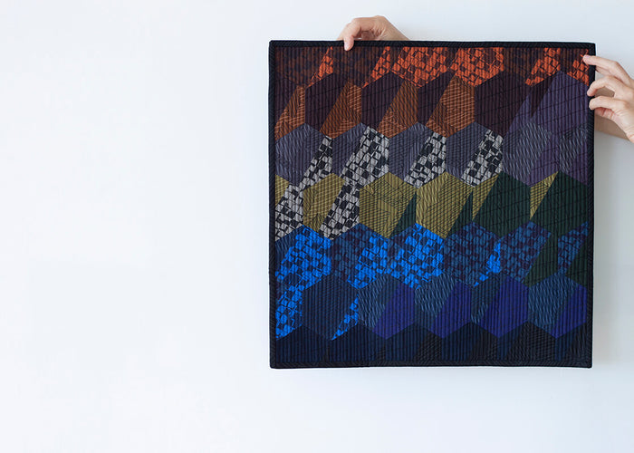 Mini quilt featuring the Arlo hexagons in instead fabrics