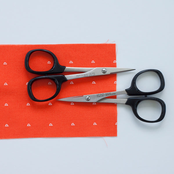 2 small scissors facing opposite directions