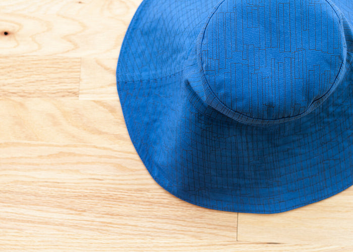 blue hat with a large brim on the ground