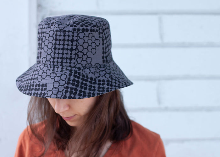 grey bucket hat with graphic fabric